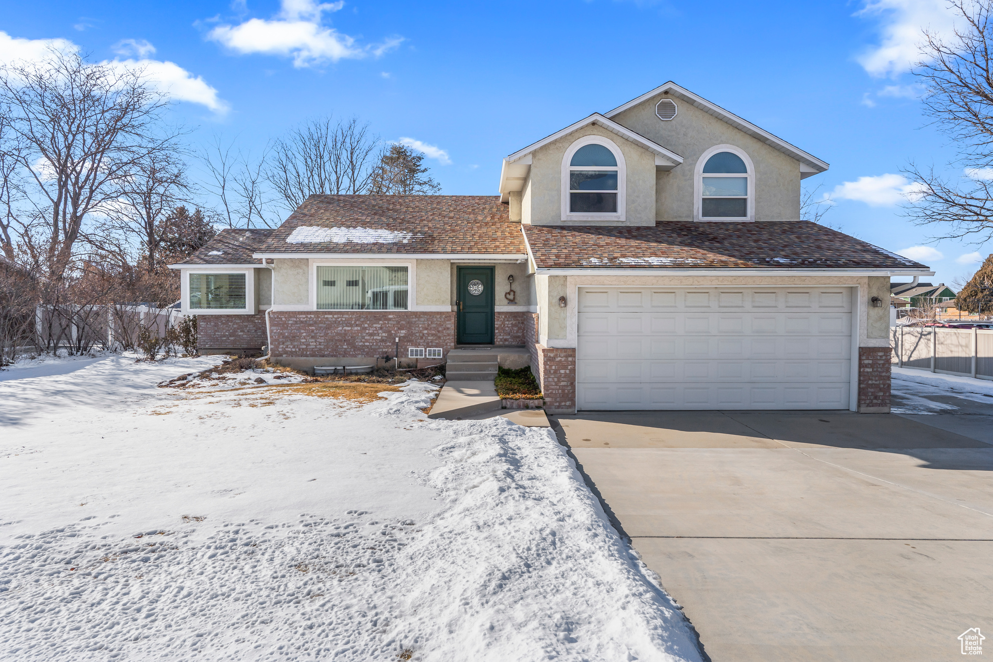 Front of property with 2 car garage and trailer parking