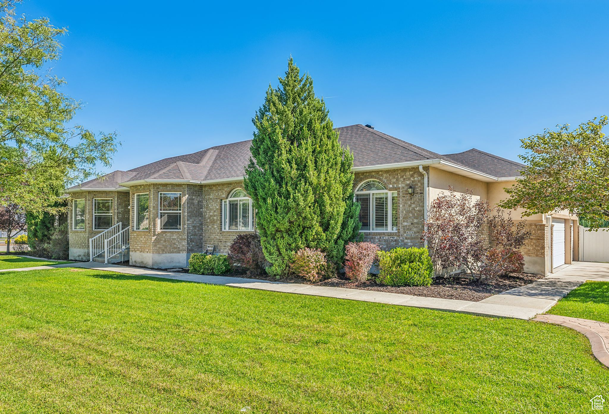 View of front of property with a garage and a front yard