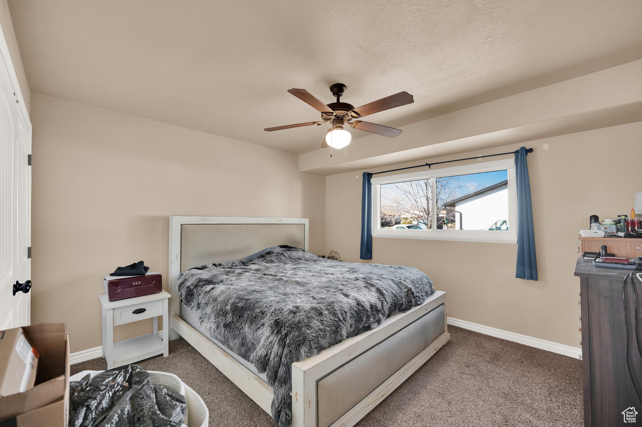 Bedroom featuring ceiling fan and carpet