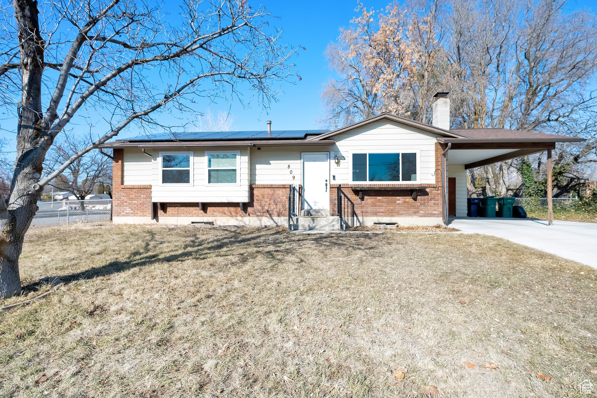 Bi-level home with a carport and a front yard