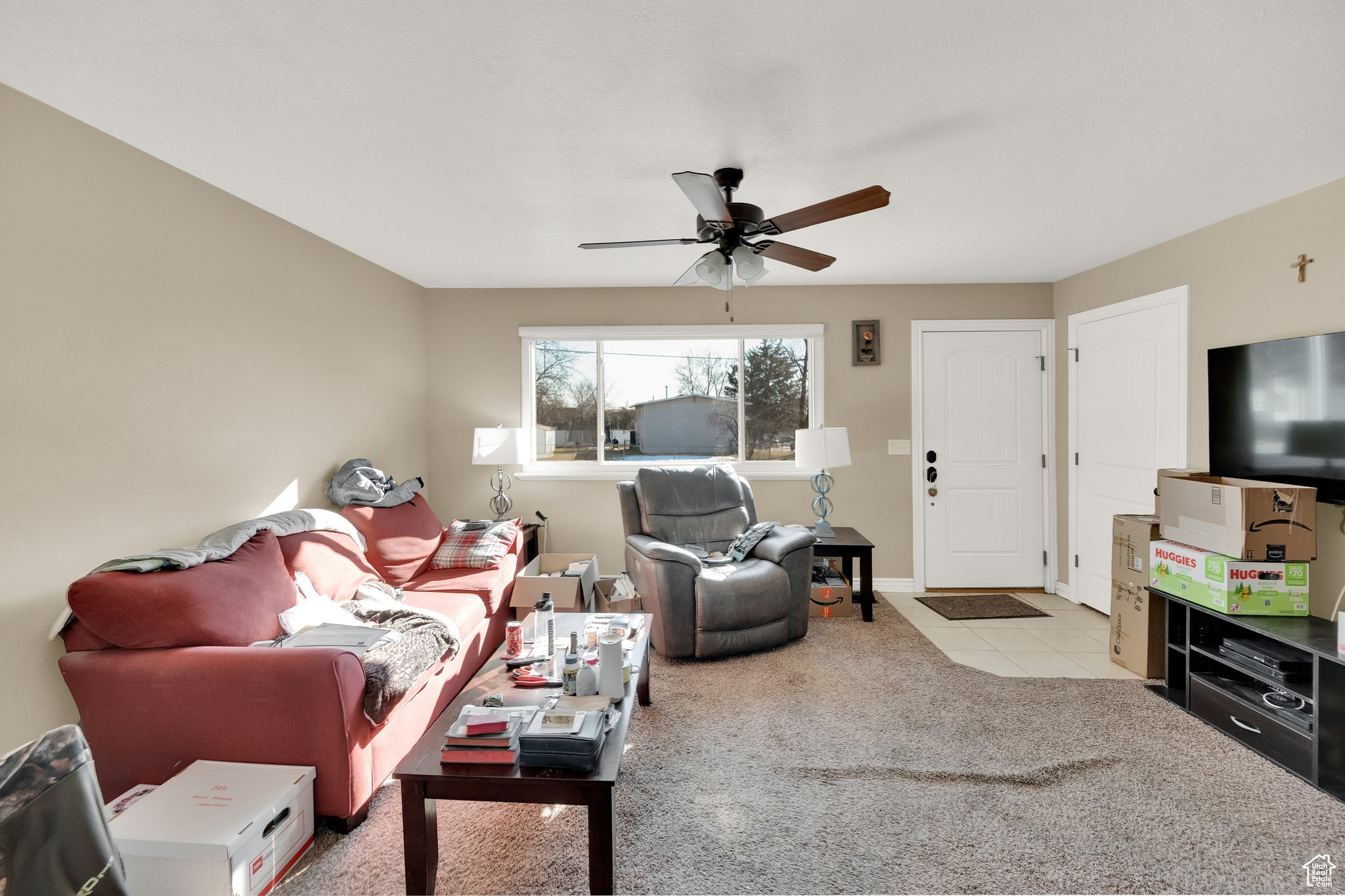 Living room featuring light carpet and ceiling fan