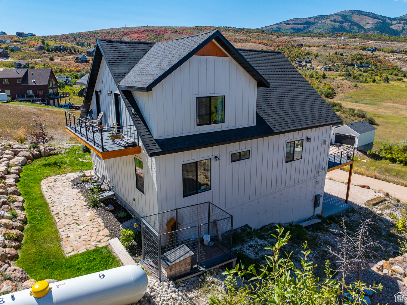 Back of property featuring a mountain view and a balcony