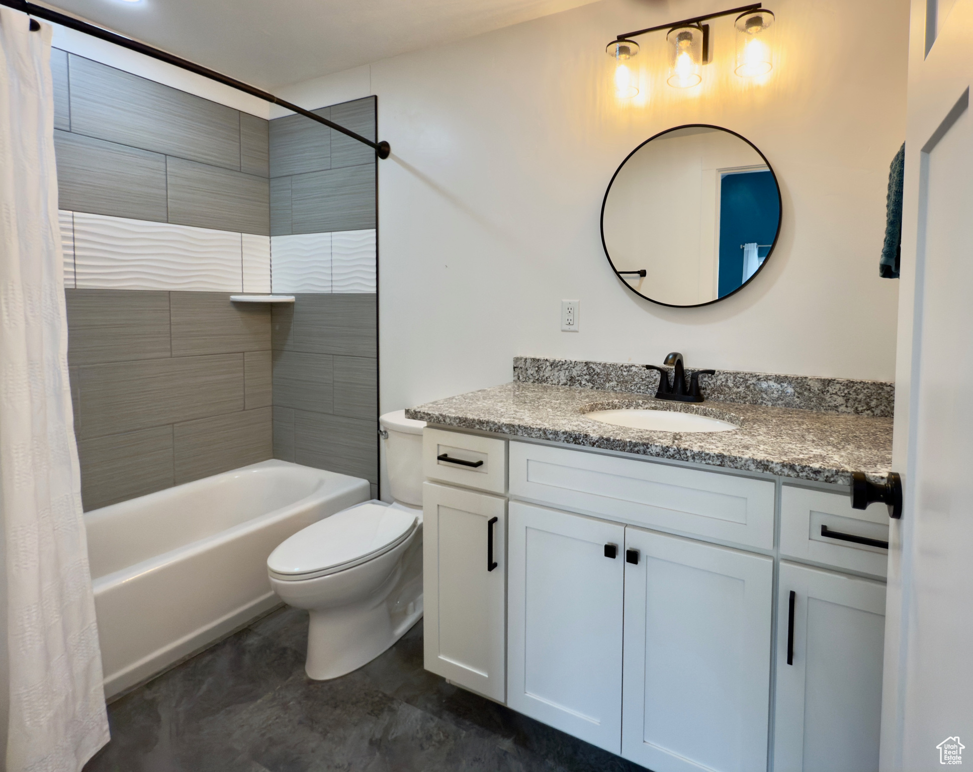 Owner's suite bathroom with vanity, toilet, and shower / bath combo with shower curtain