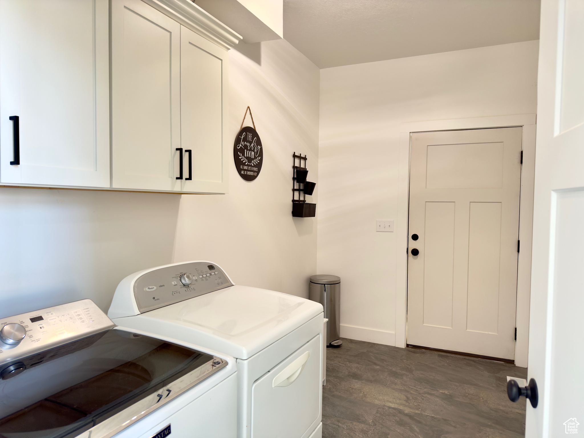 Laundry room featuring cabinets and washing machine and clothes dryer