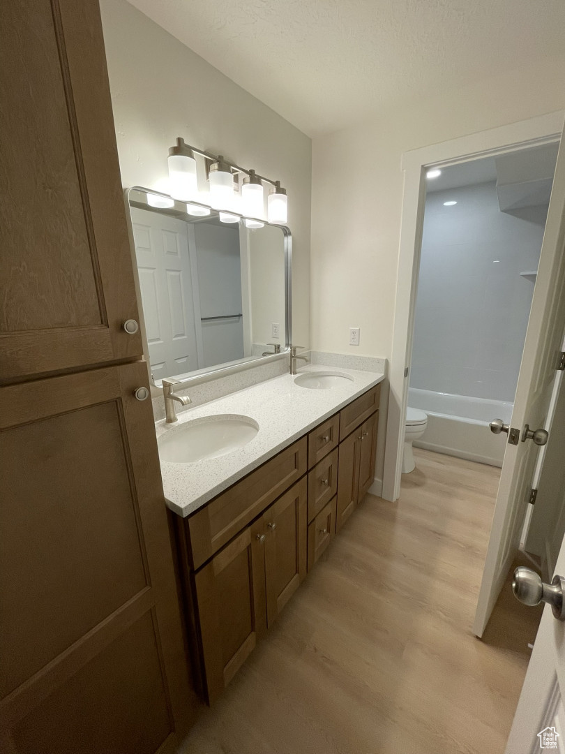 Basement bath with double sinks and separate toilet/shower closet