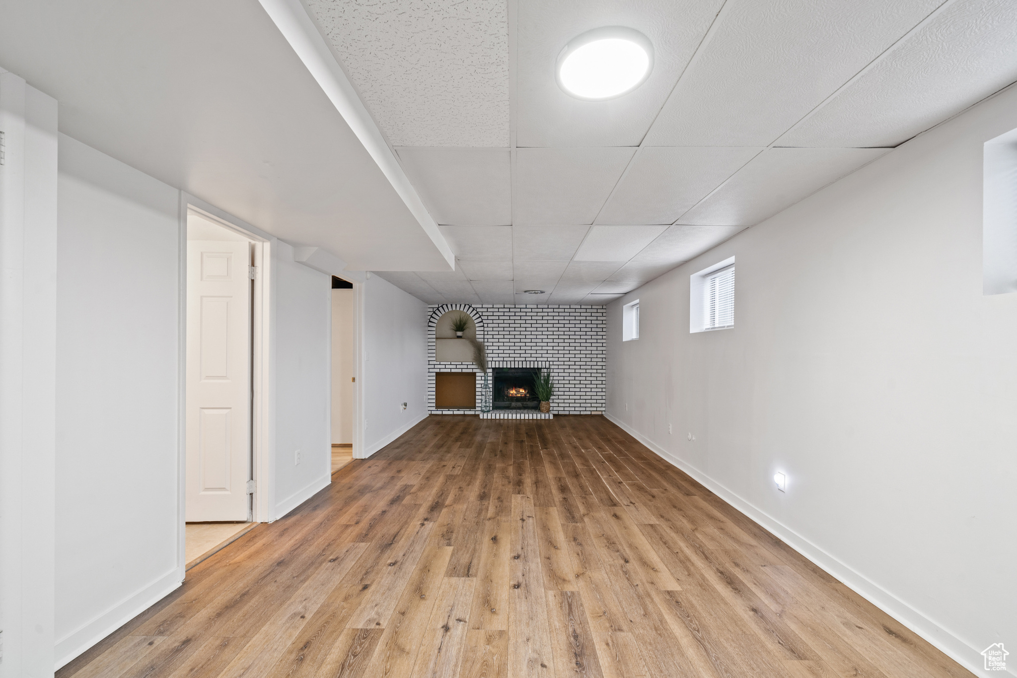 Basement featuring, a fireplace, and light hardwood / wood-style floors.