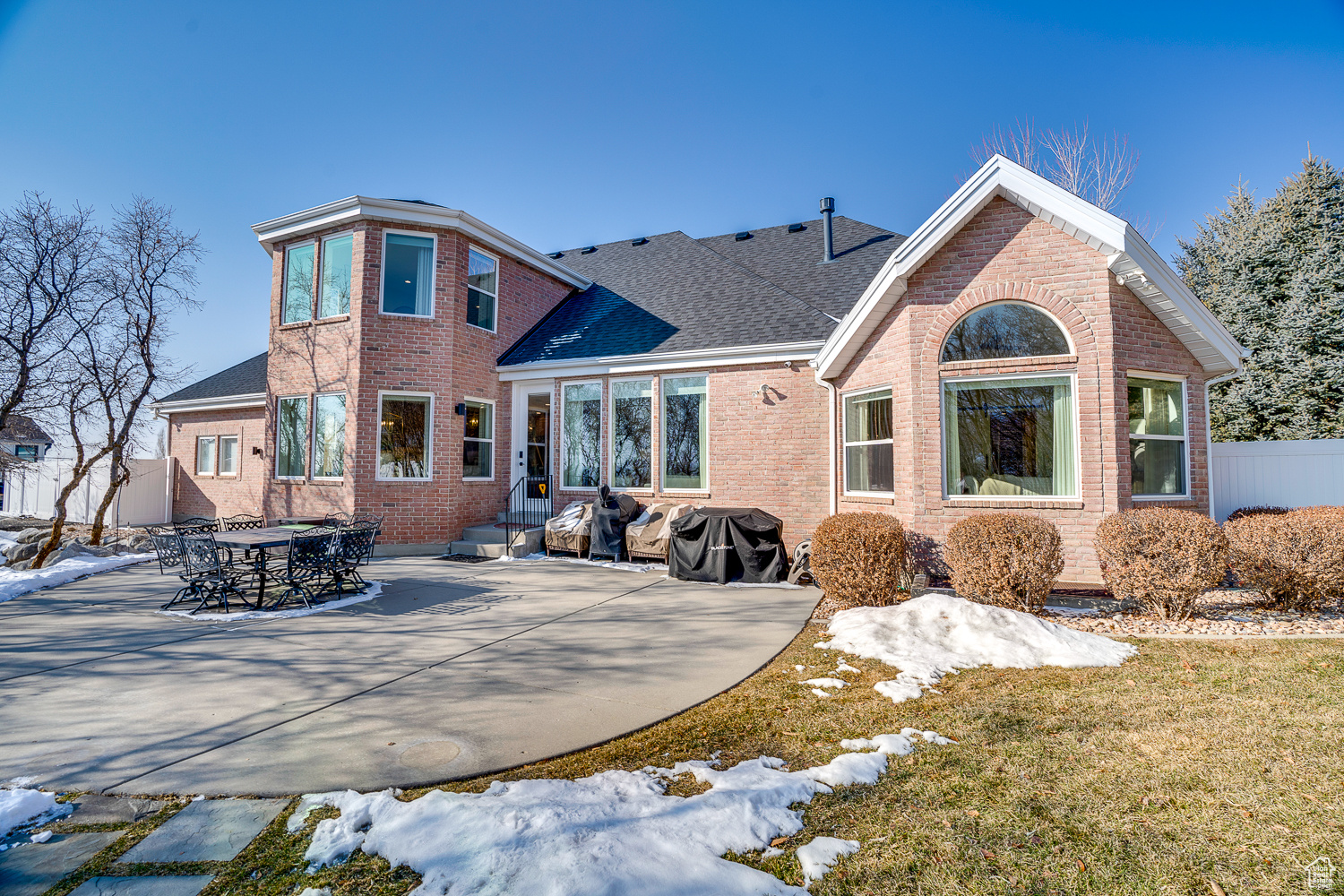 Rear view of property featuring a patio and a yard