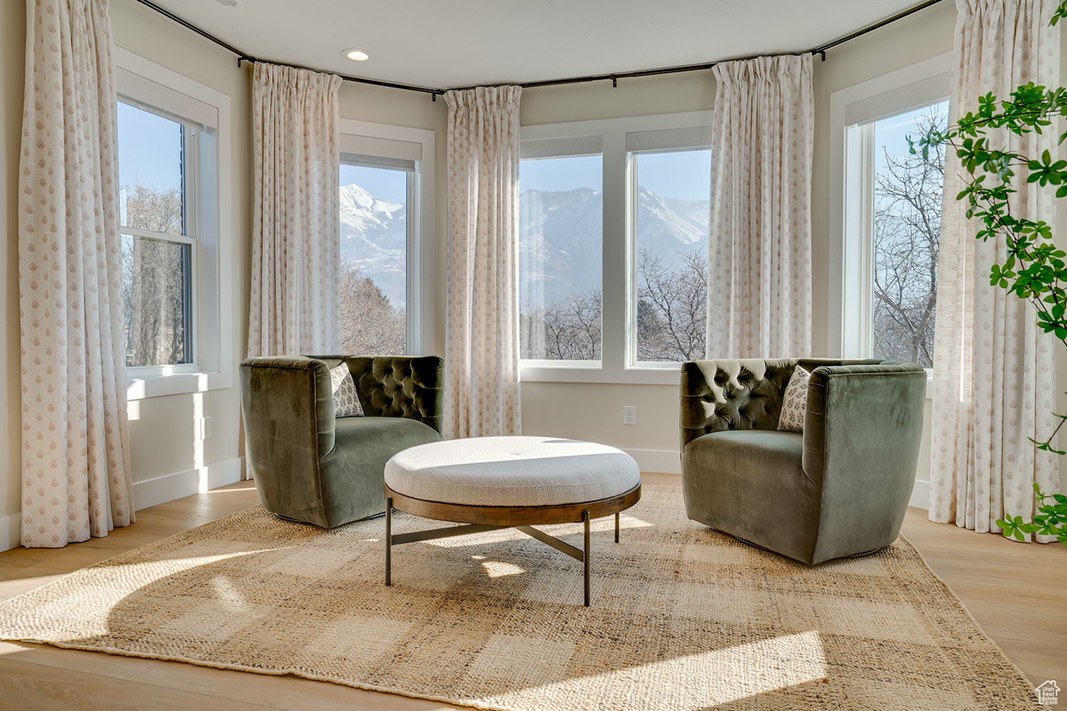 Living area with a mountain view and hardwood / wood-style floors