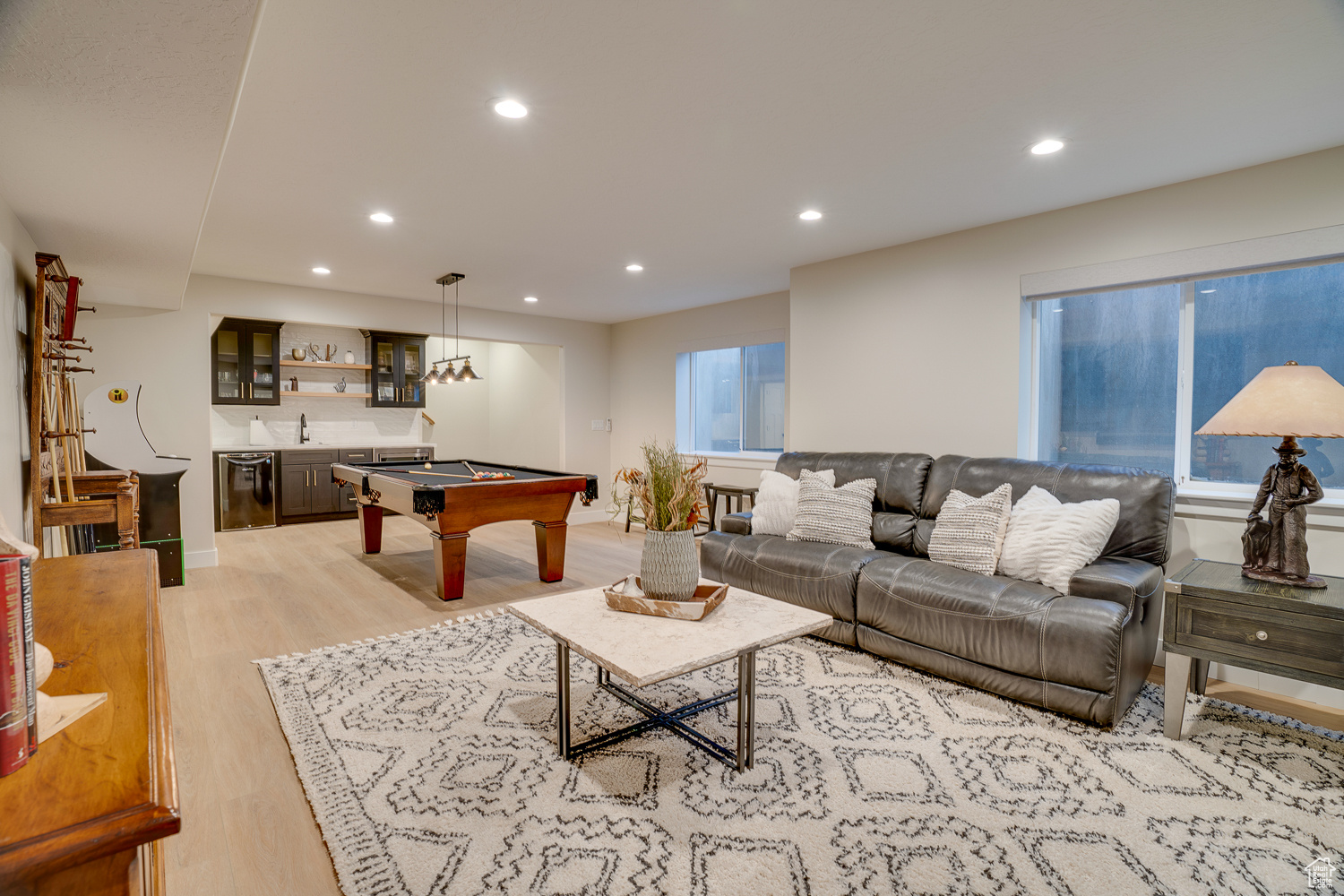 Interior space with billiards, indoor wet bar, and light wood-type flooring