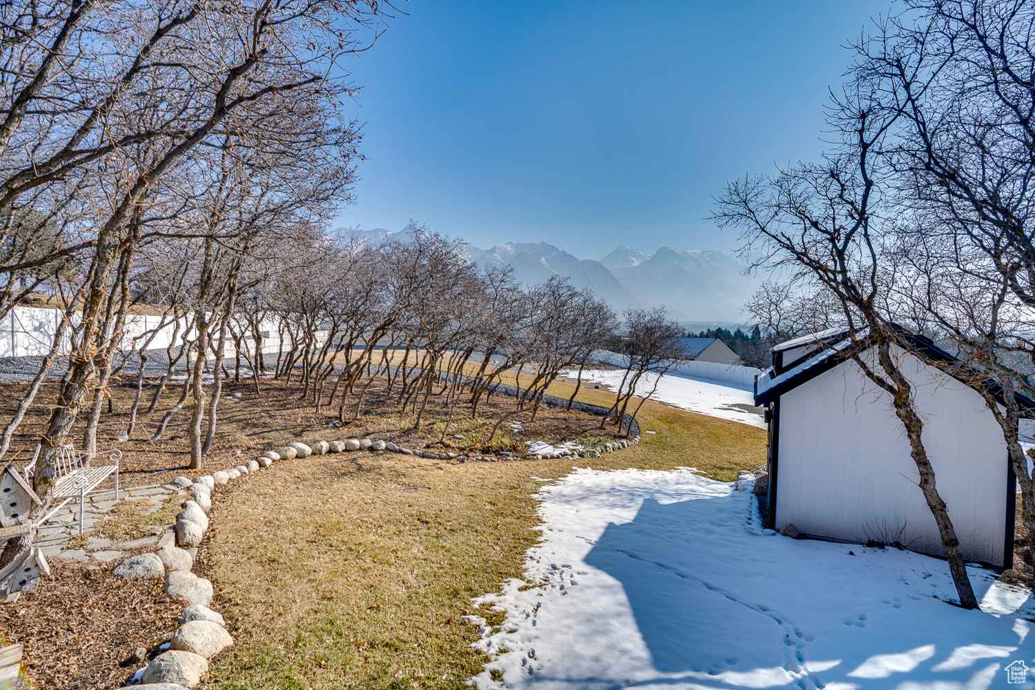 Snowy yard with a mountain view