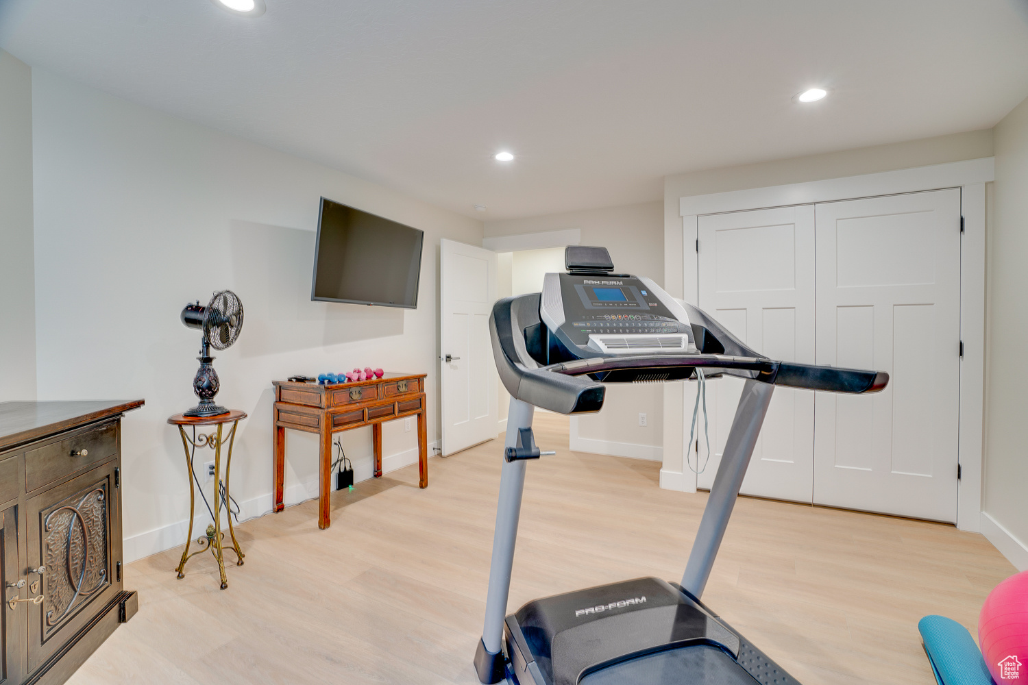 Exercise area featuring light hardwood / wood-style floors