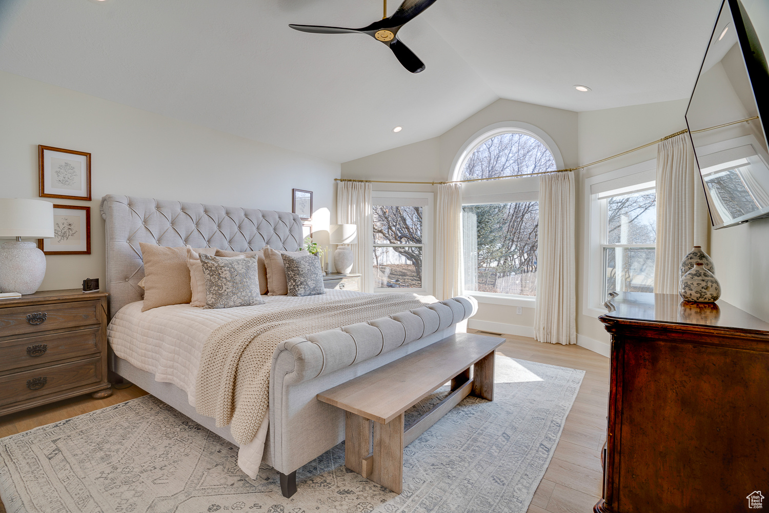 Bedroom with lofted ceiling, ceiling fan, and light hardwood / wood-style flooring