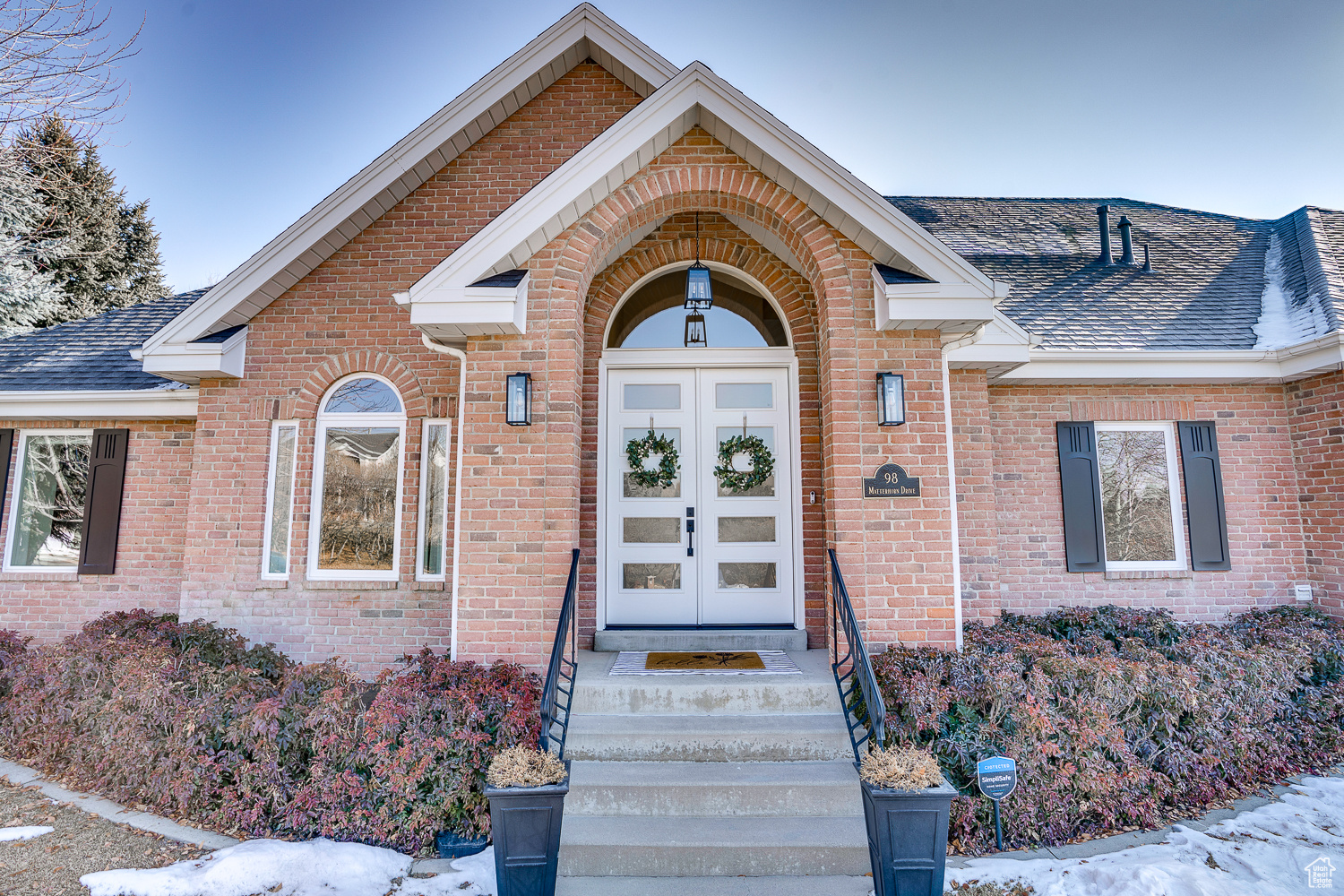 Snow covered property entrance featuring french doors