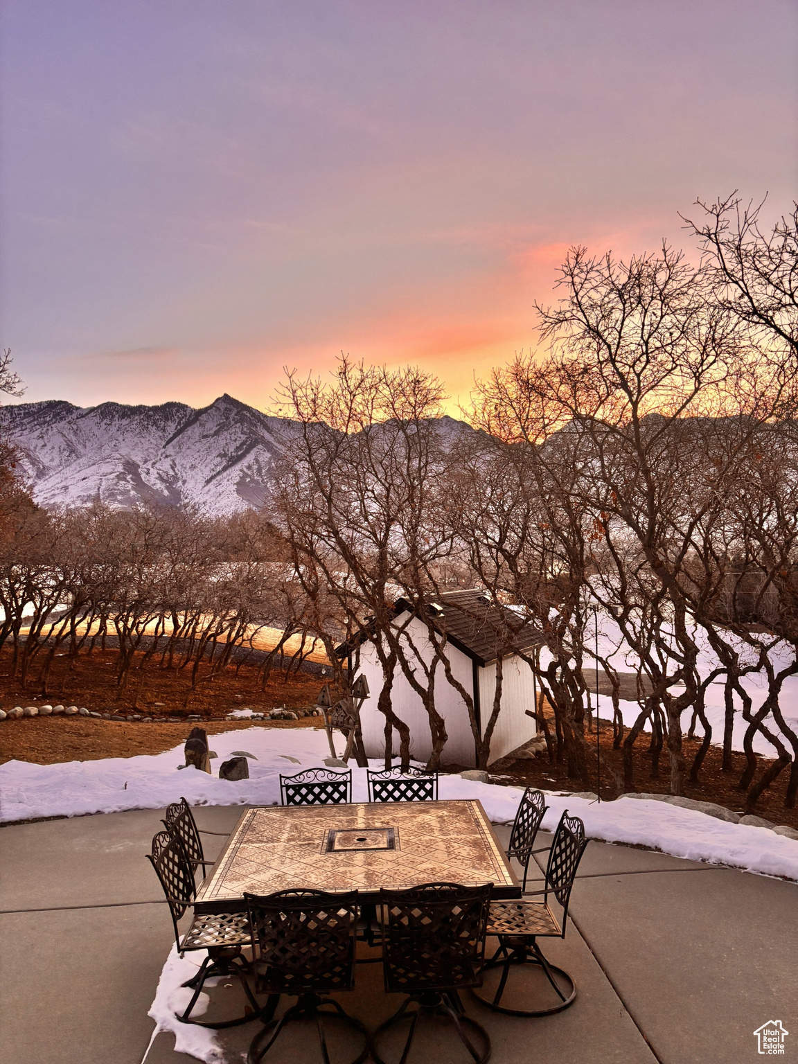 Snow covered patio with a mountain view