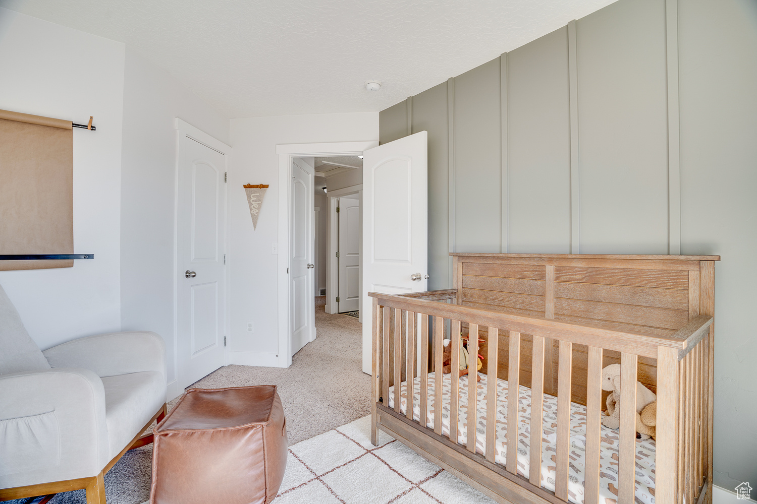 Bedroom featuring light colored carpet