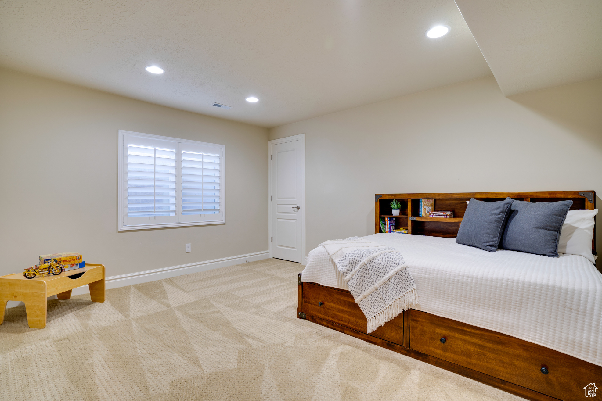 Bedroom featuring light colored carpet