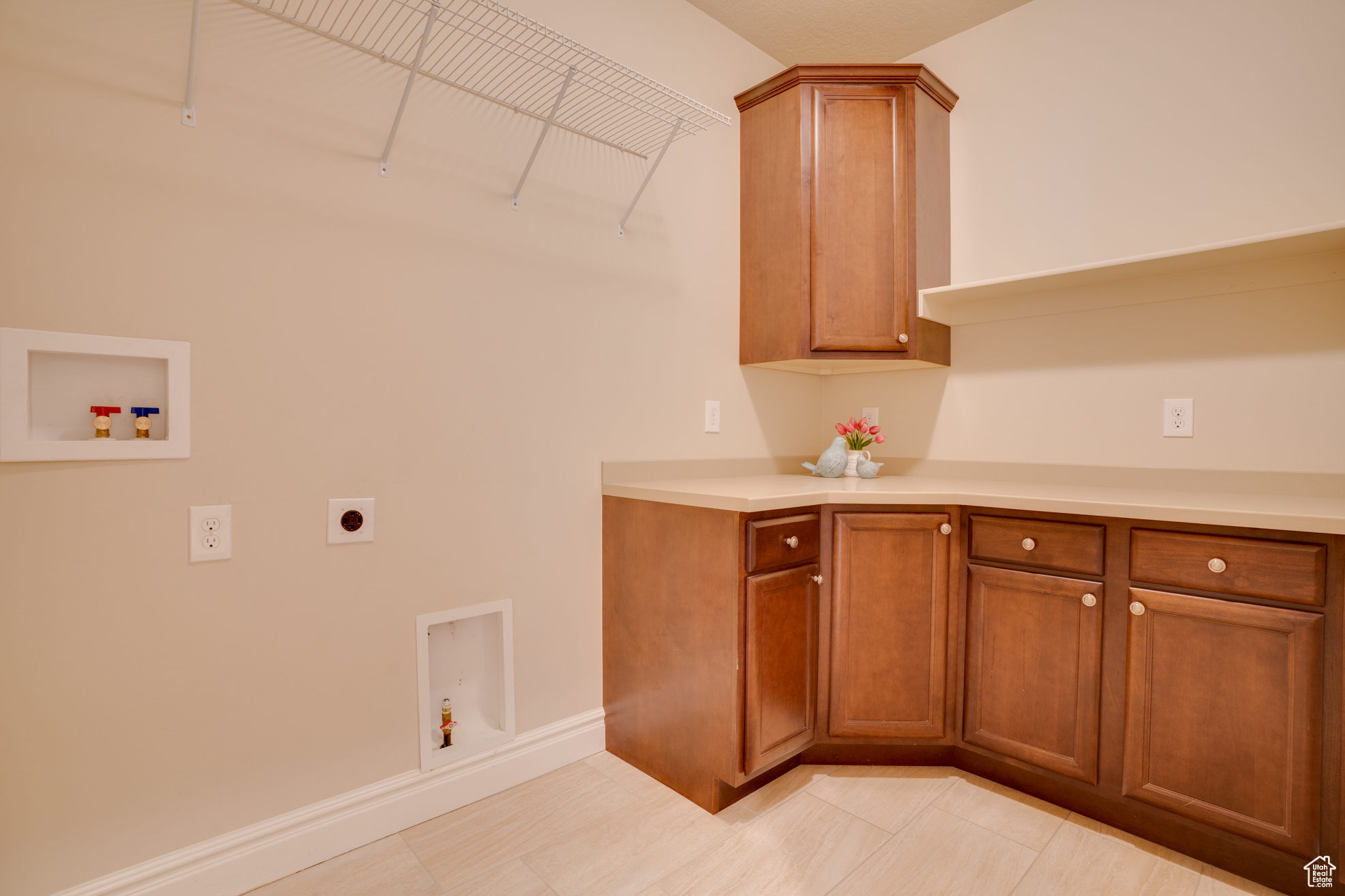 Washroom with cabinets, hookup for an electric dryer, and hookup for a washing machine