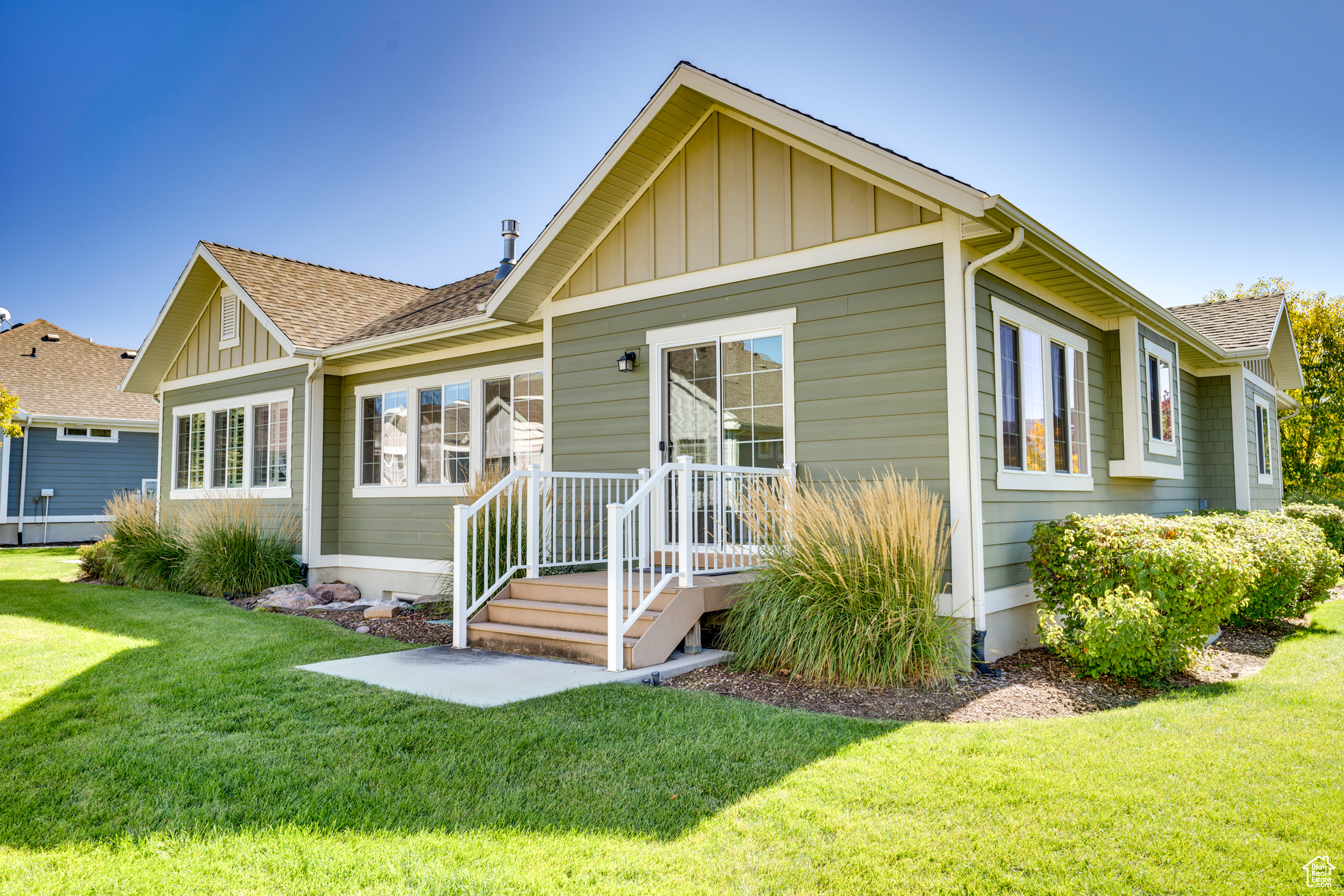 Rear view of property featuring a lawn