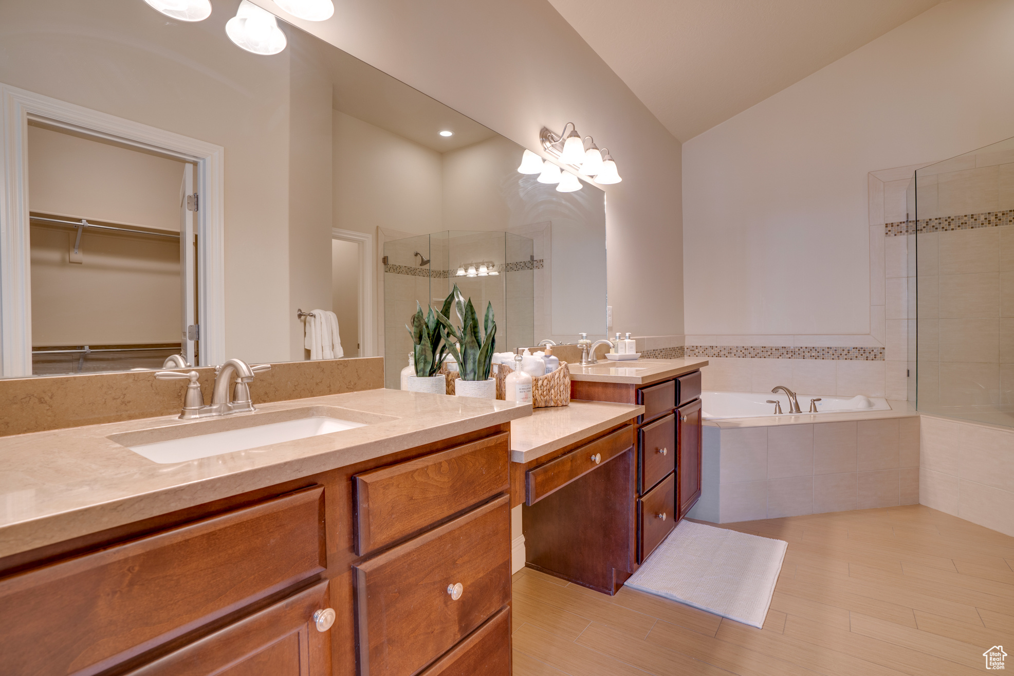 Bathroom with lofted ceiling, independent shower and bath, and vanity