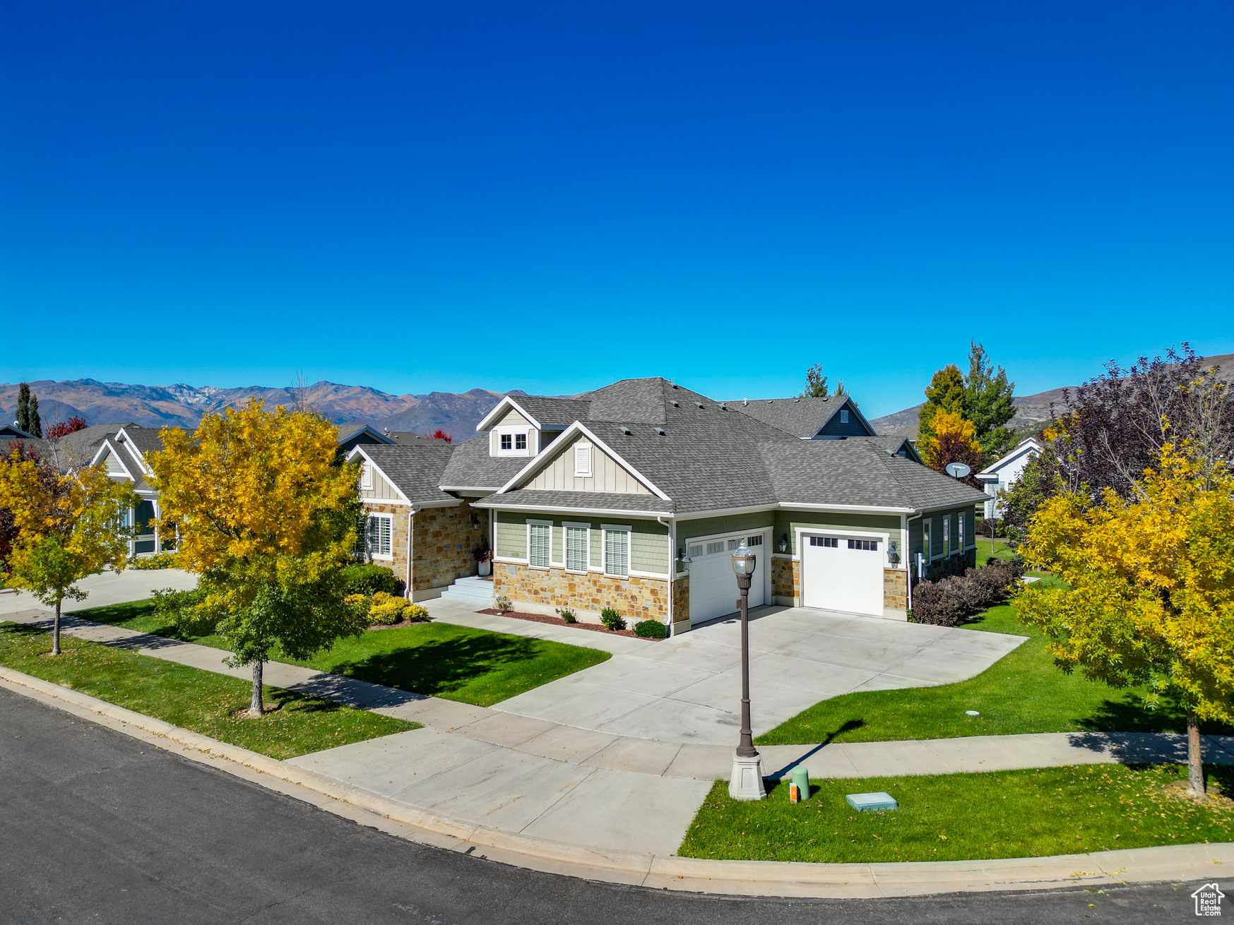 Craftsman-style home featuring a mountain view, a garage, and a front yard