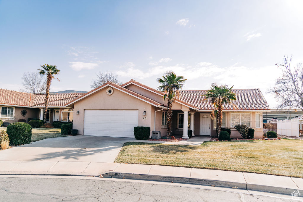 View of front of home featuring a garage and a front yard