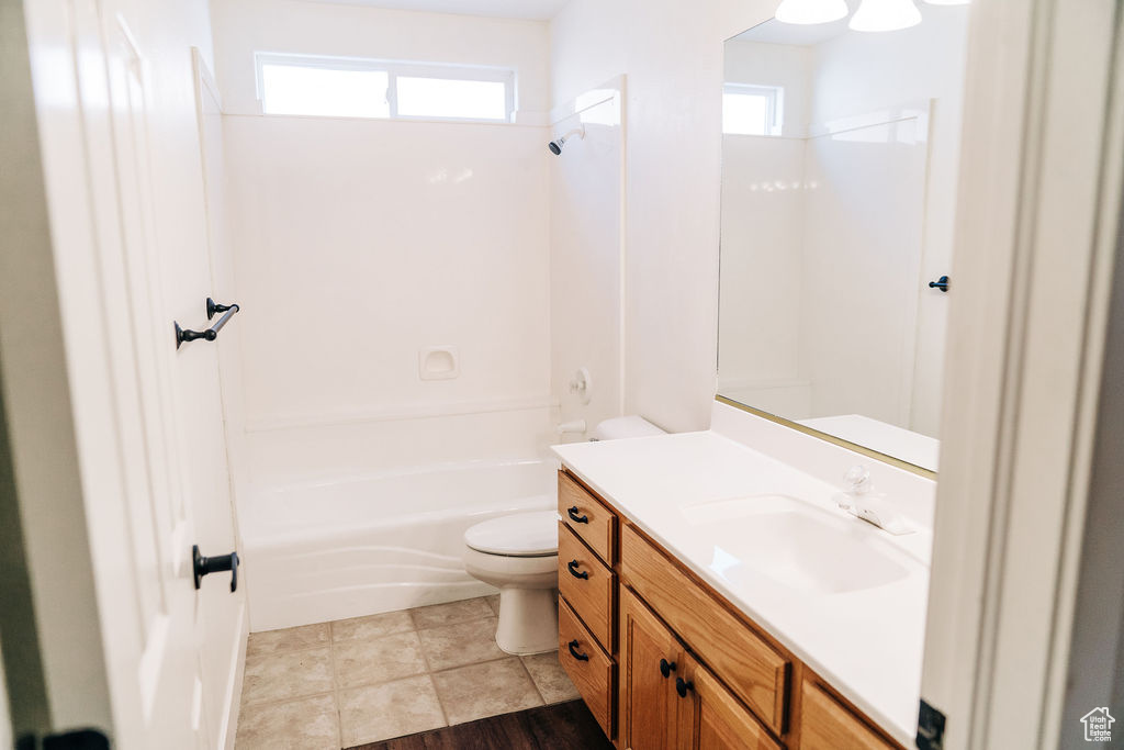 Full bathroom with shower / bathtub combination, vanity, and toilet