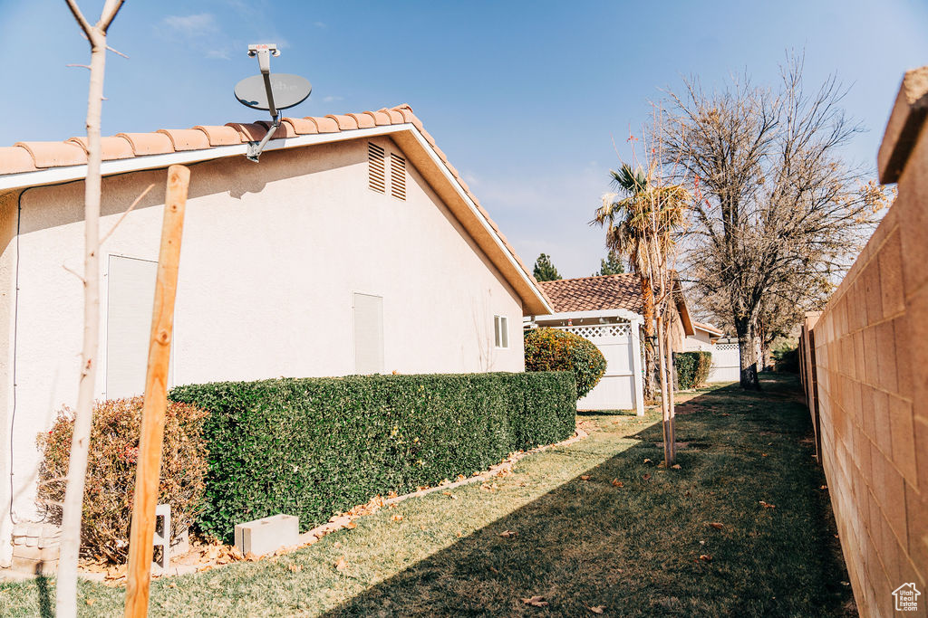 View of side of property featuring a yard