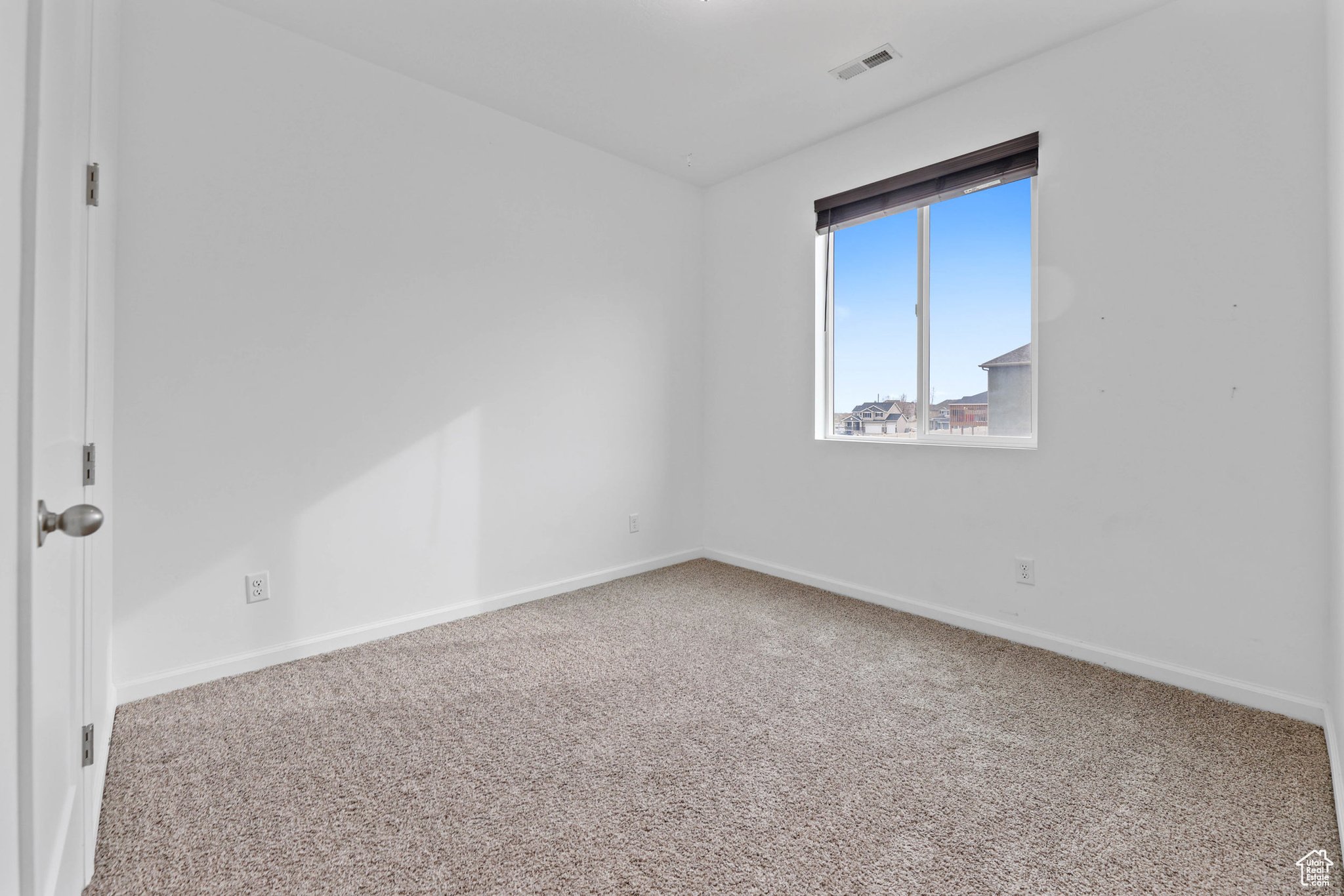 Spare room featuring carpet flooring