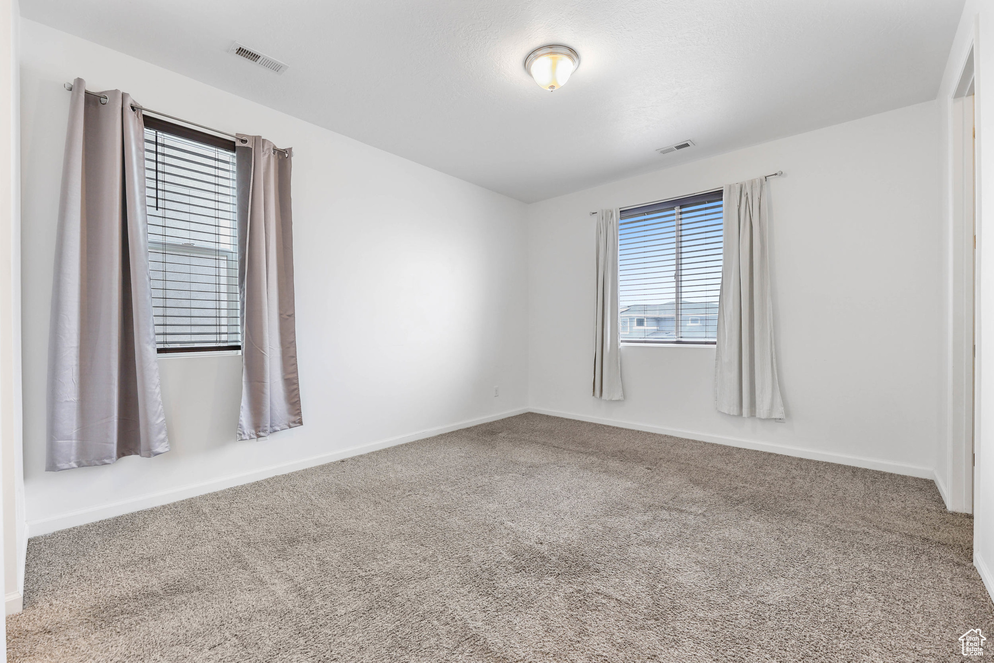 Unfurnished primary bedroom with carpet floors