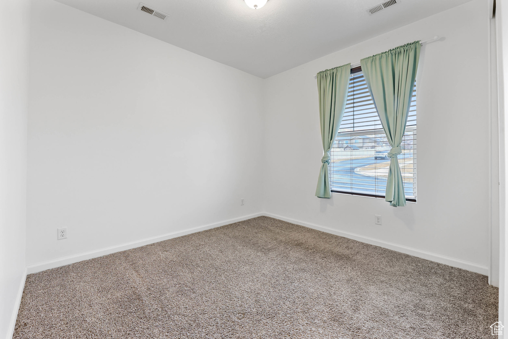 Empty room with carpet flooring