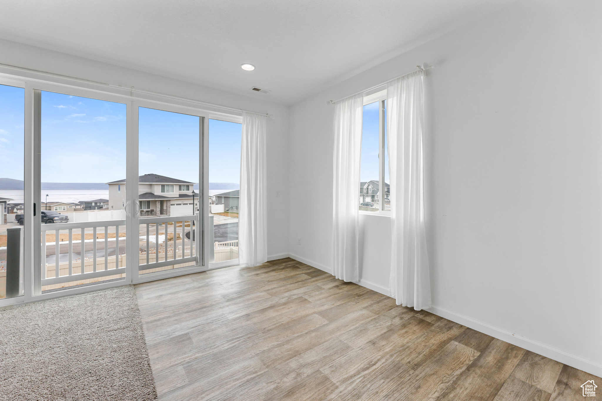 Dining room featuring light hardwood / wood-style floors and a water view