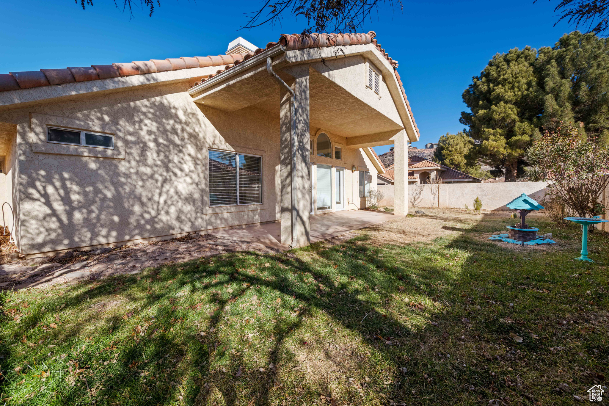 Rear view of house with a patio area and a lawn