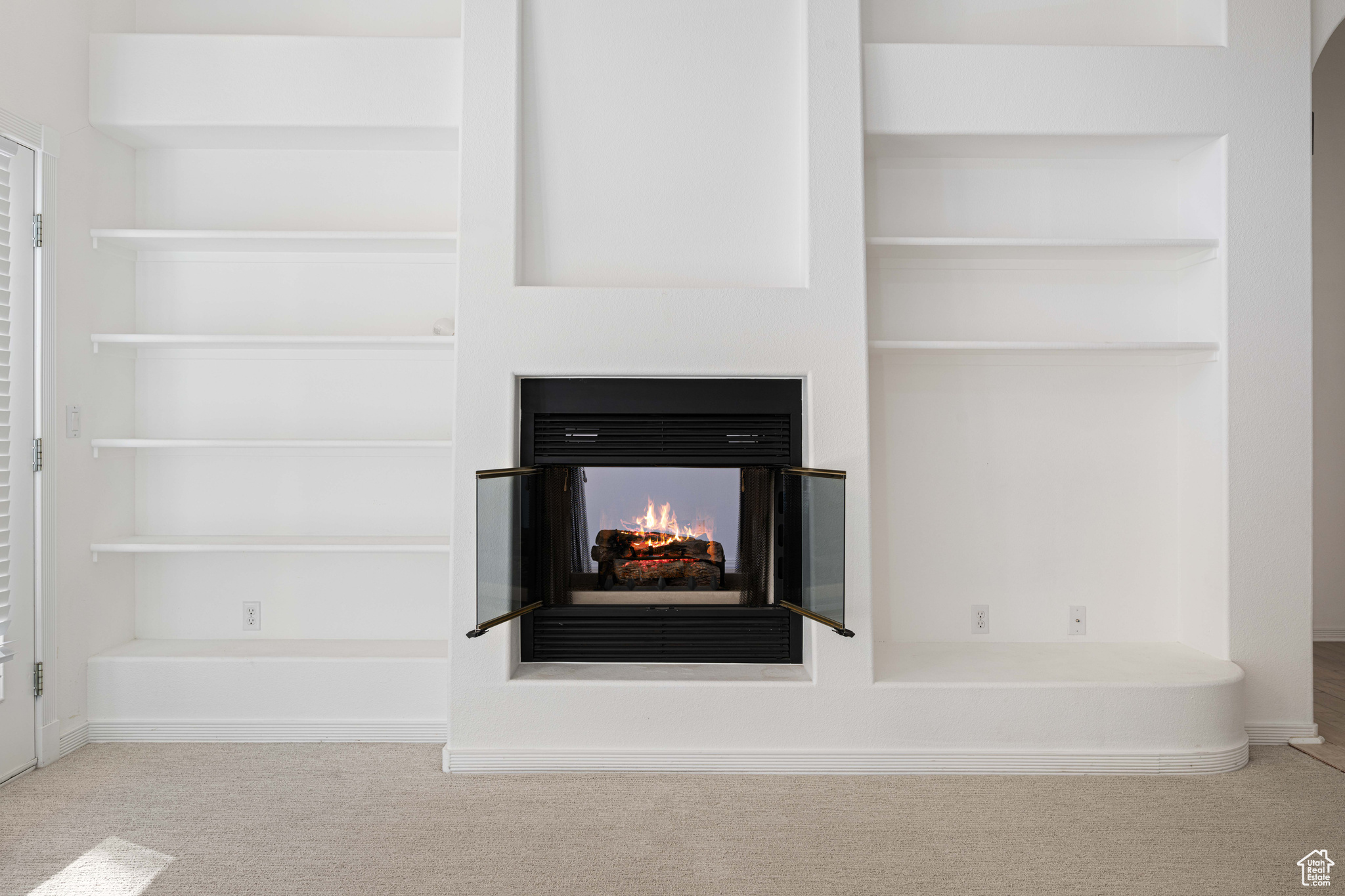 Interior details featuring a multi sided fireplace and carpet floors