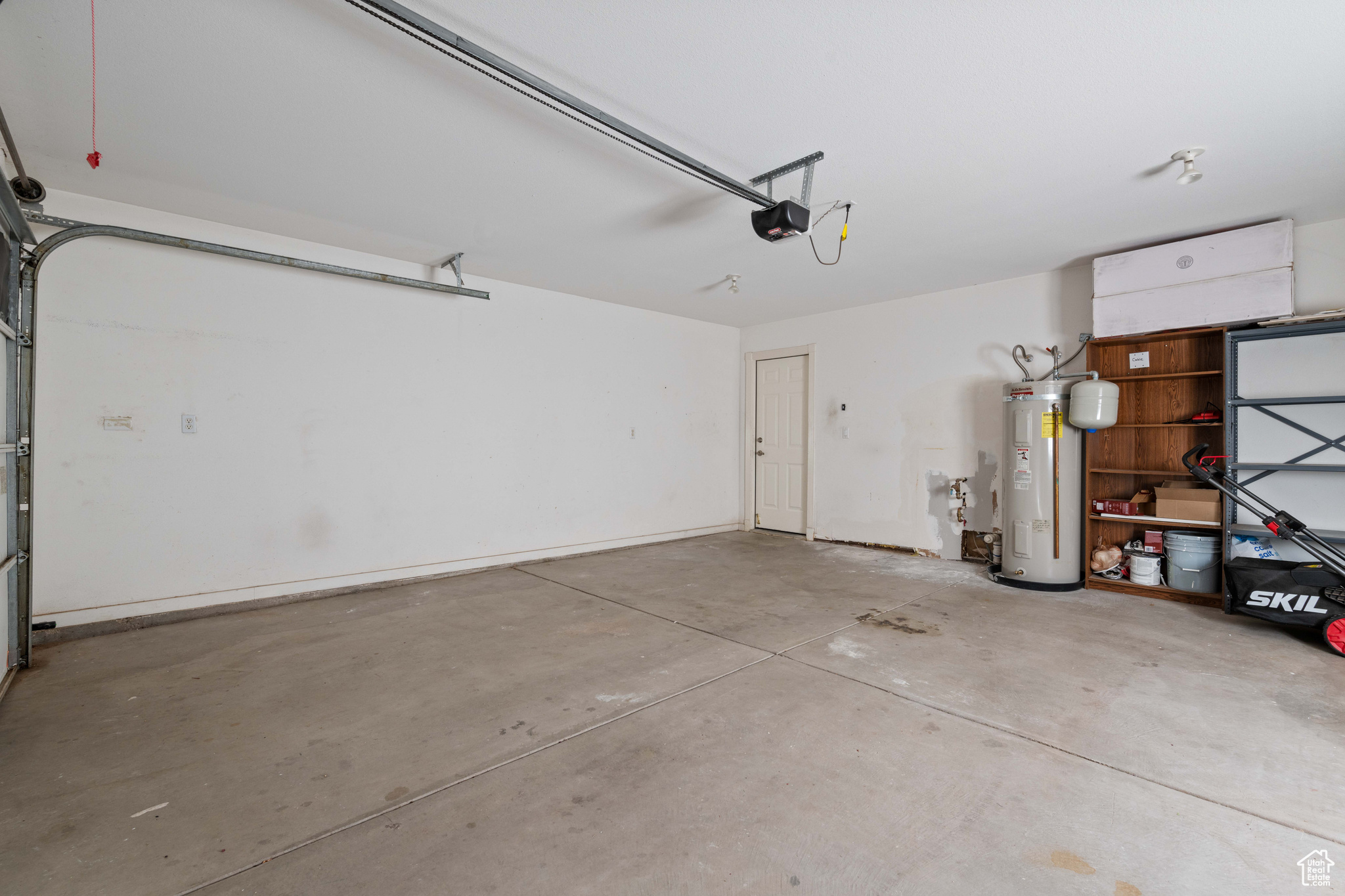 Garage with a garage door opener and electric water heater