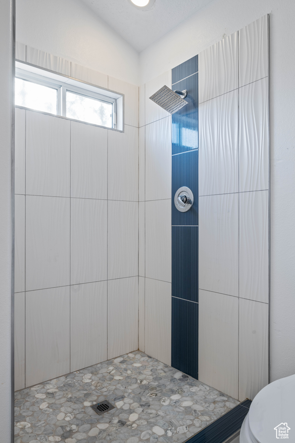 Bathroom with toilet and tiled shower