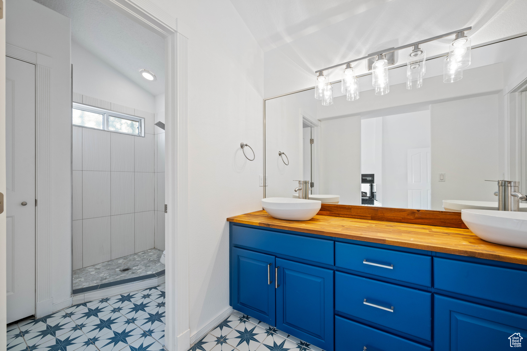 Bathroom with vanity and a tile shower