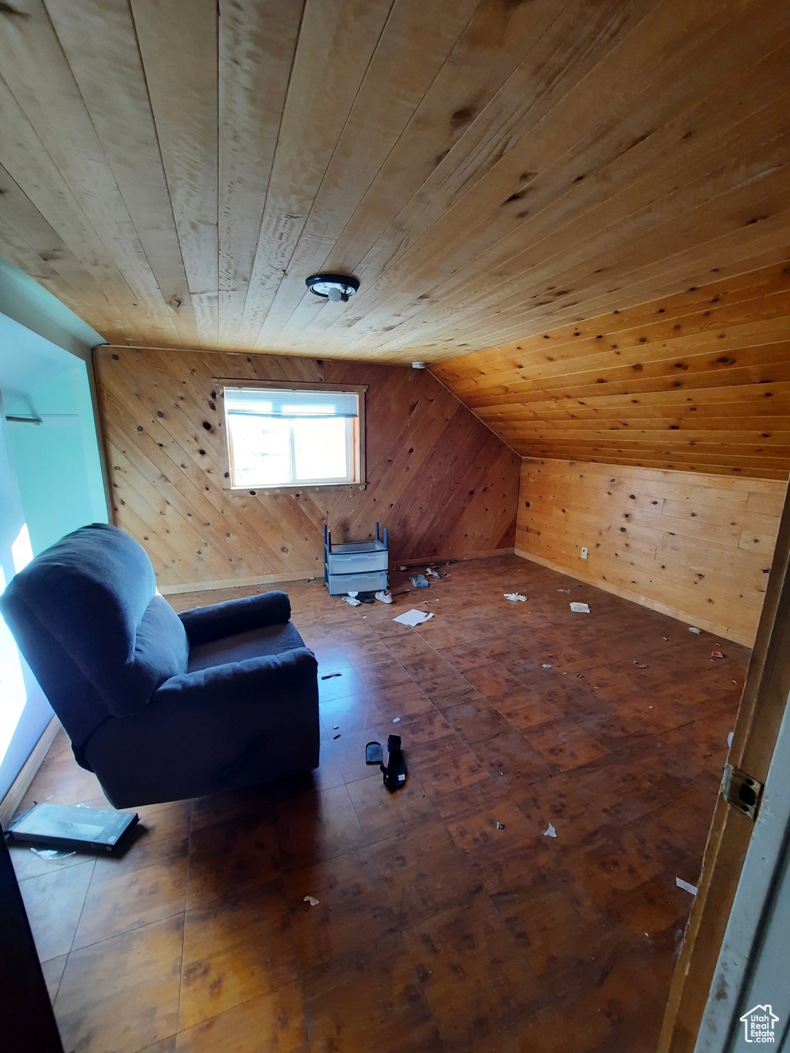 Bonus room with hardwood / wood-style flooring, lofted ceiling, wood ceiling, and wooden walls