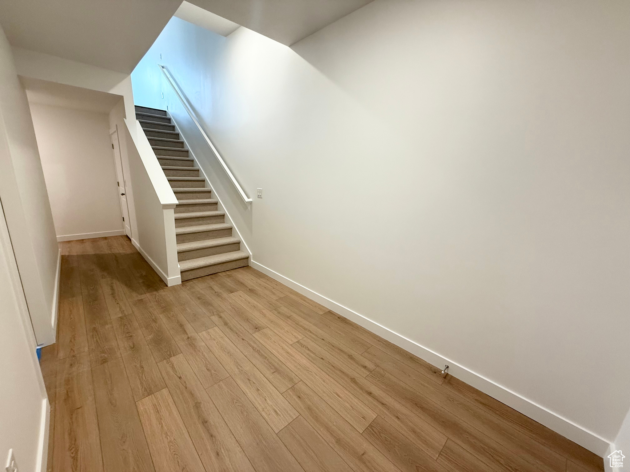 Basement featuring light wood-type flooring