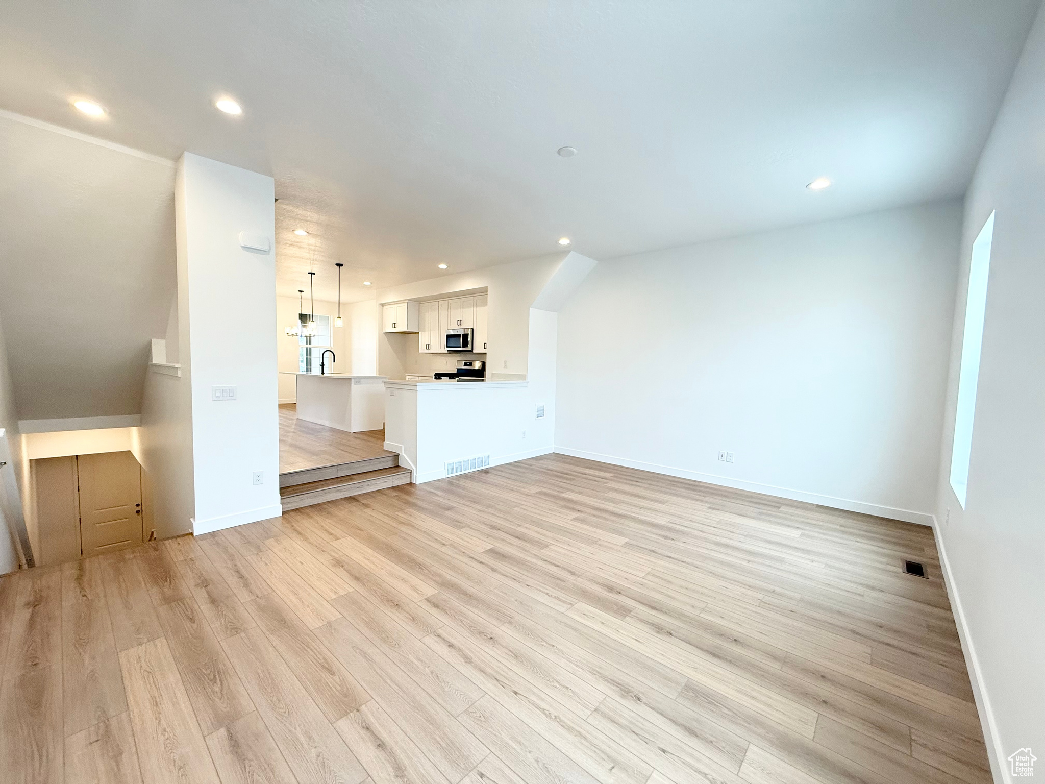 Unfurnished living room featuring light wood-type flooring