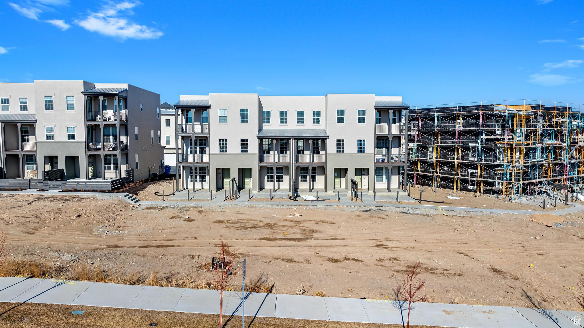 Front of building with large green space. Landscaping coming spring 2025