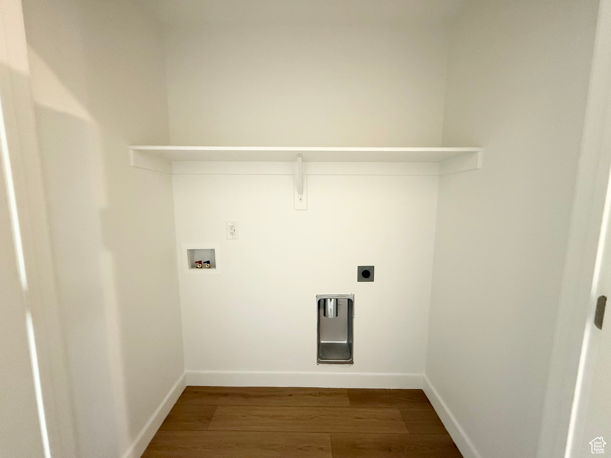 Washroom with hookup for a washing machine, wood-type flooring, and hookup for an electric dryer