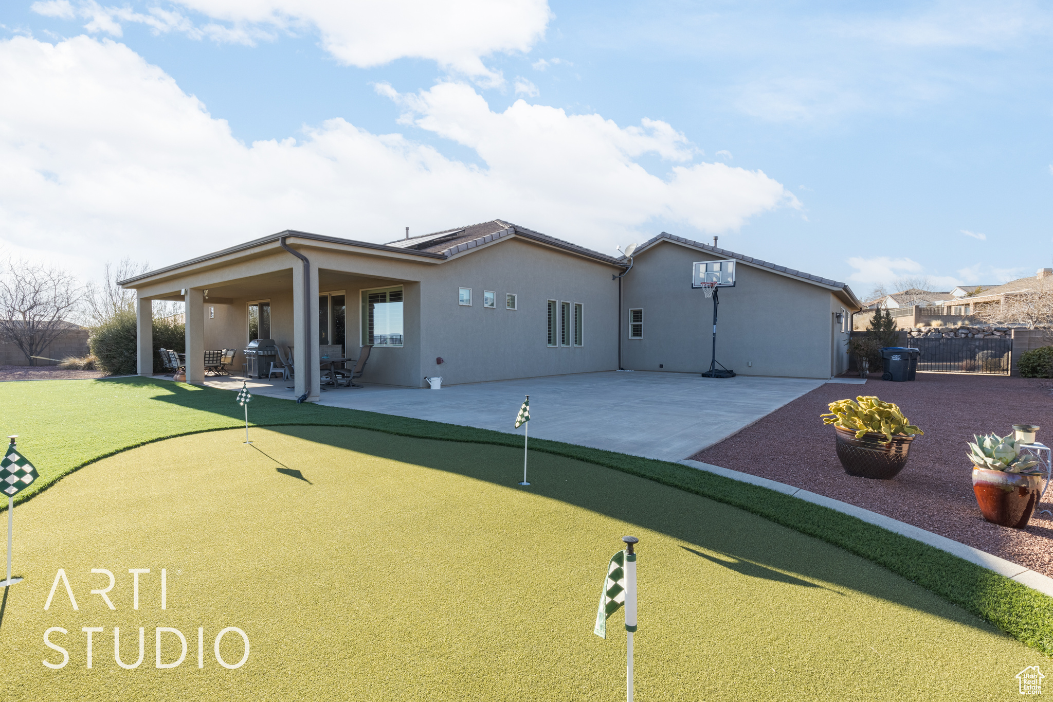 Back of property with a 4 hold putting green