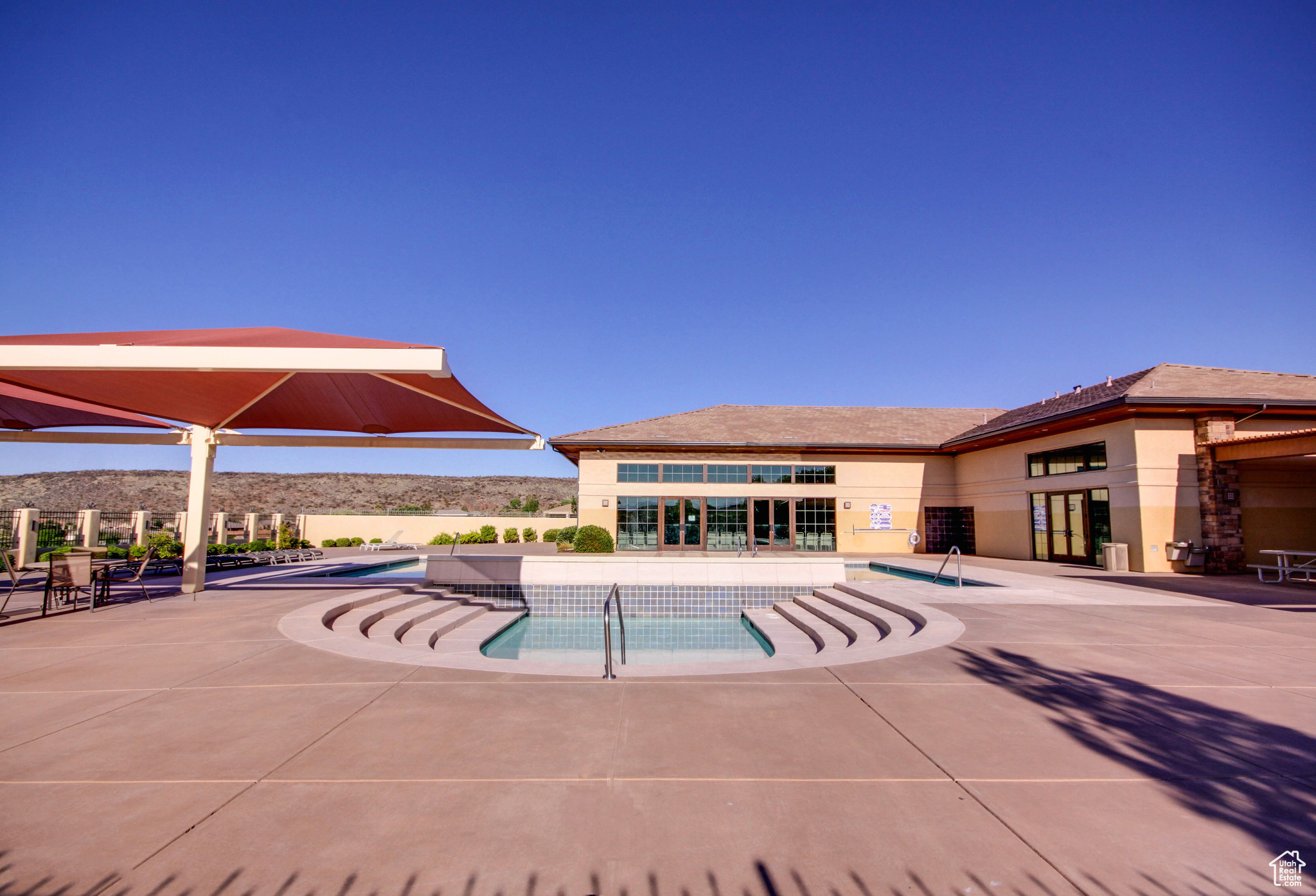 View of community swimming pool featuring a patio area