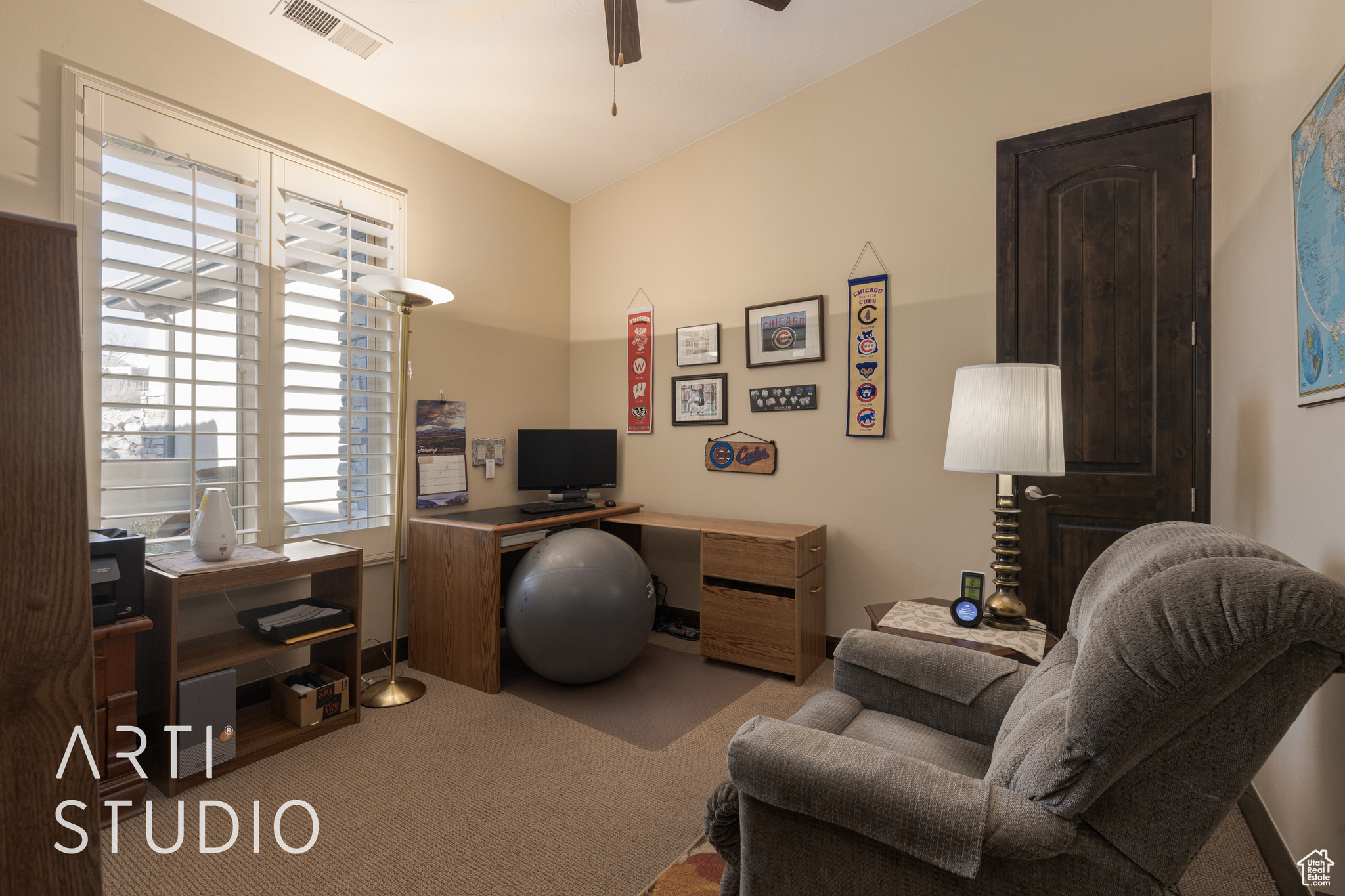 Carpeted office space with ceiling fan