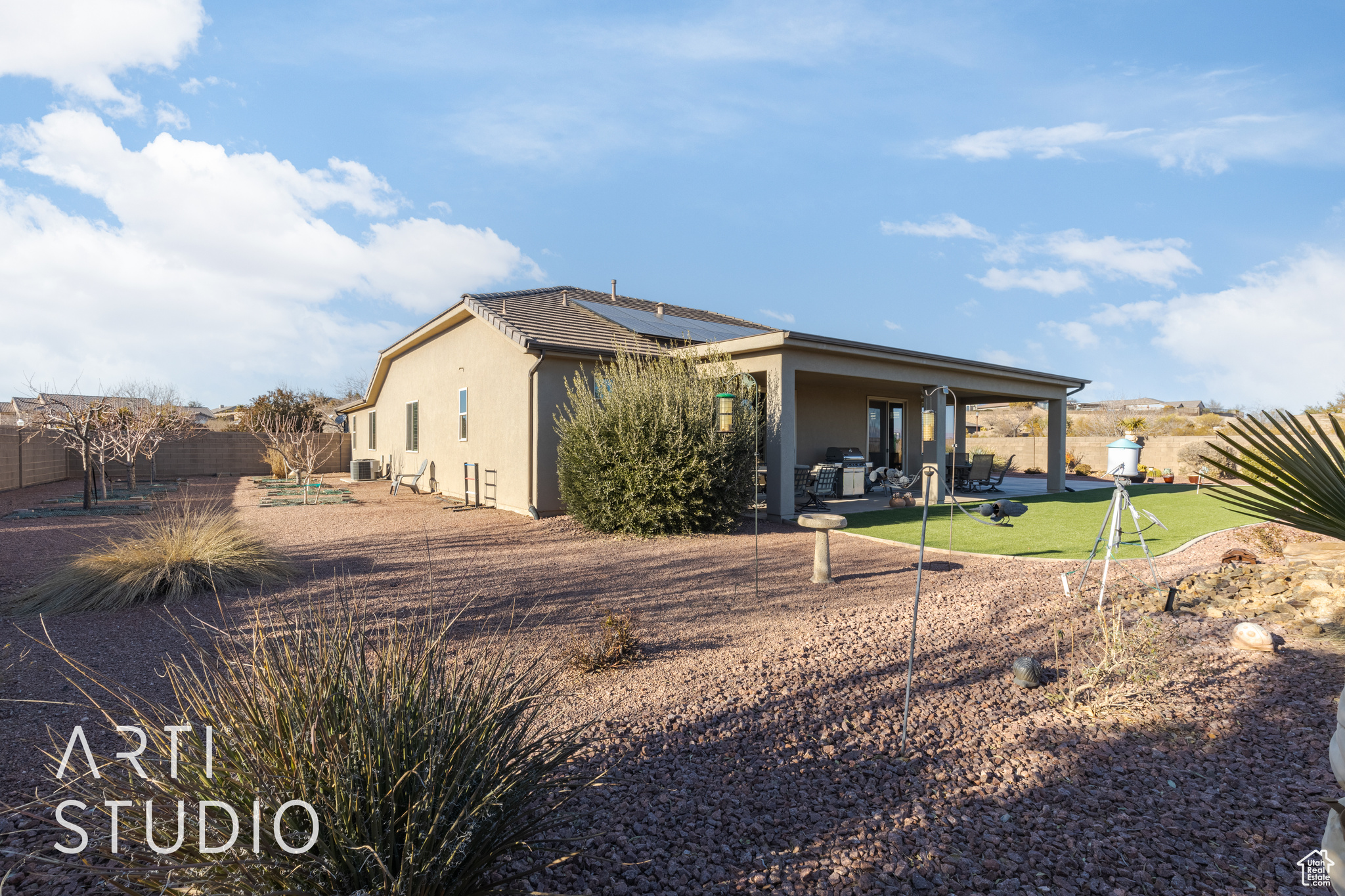 View of side of property featuring 10 fruit trees including 4 apple, 2 peach, 1 pomegranite, 1 nectarine and 2 figs.