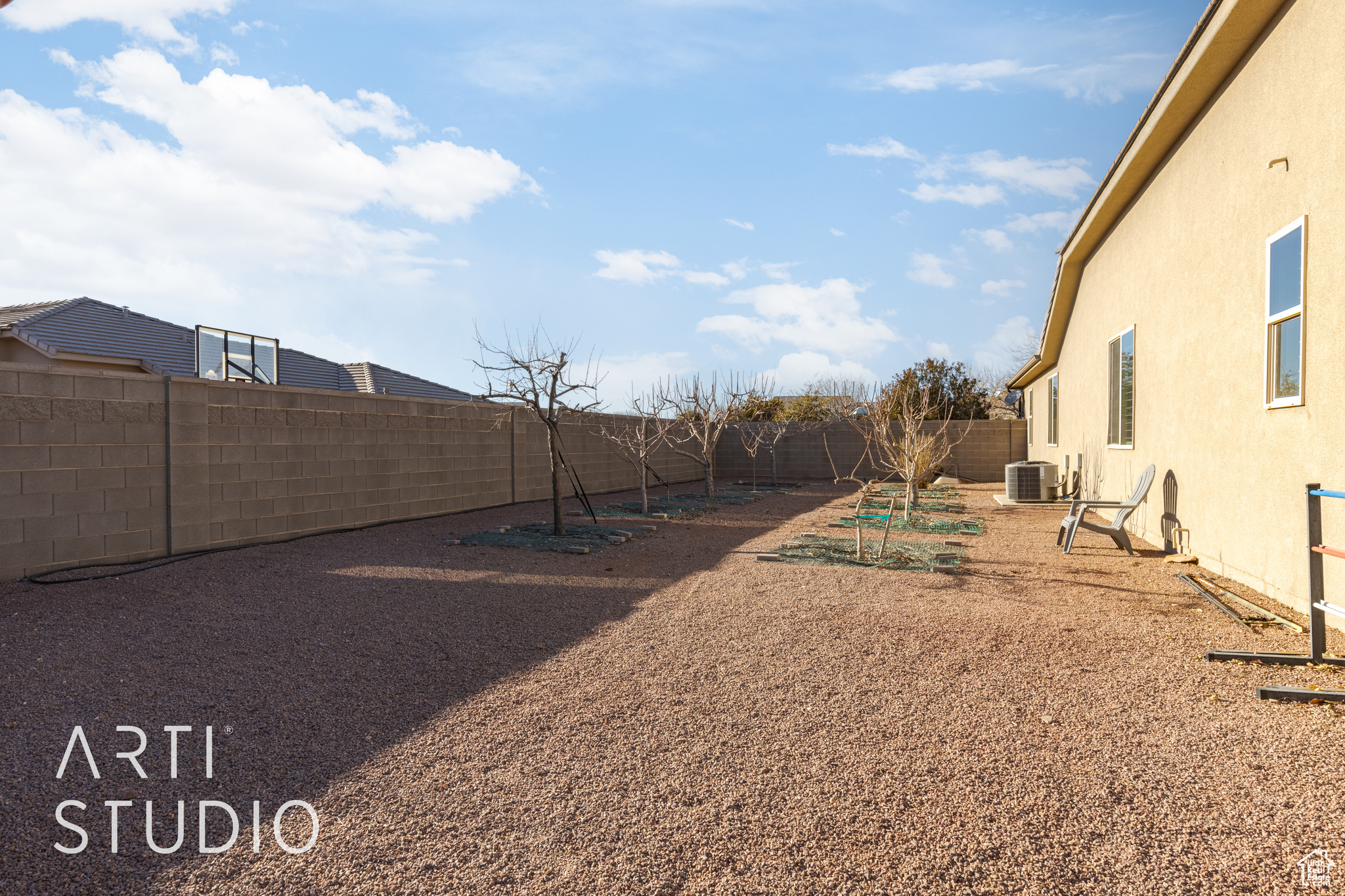 View of side yard featuring 4 apple trees, 2 peach trees, 1 pomegranite tree, 1 nectarine tree and 2 fig trees