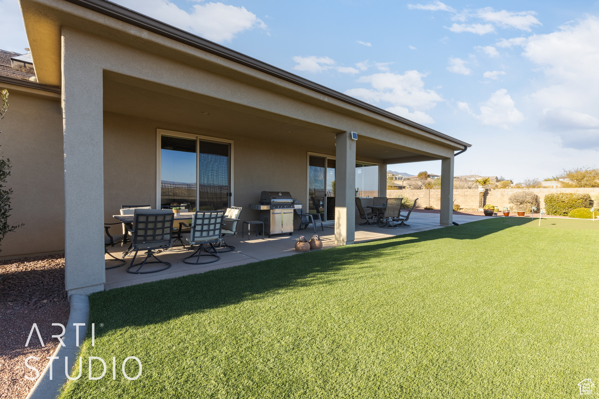 Back of house with a patio and a yard