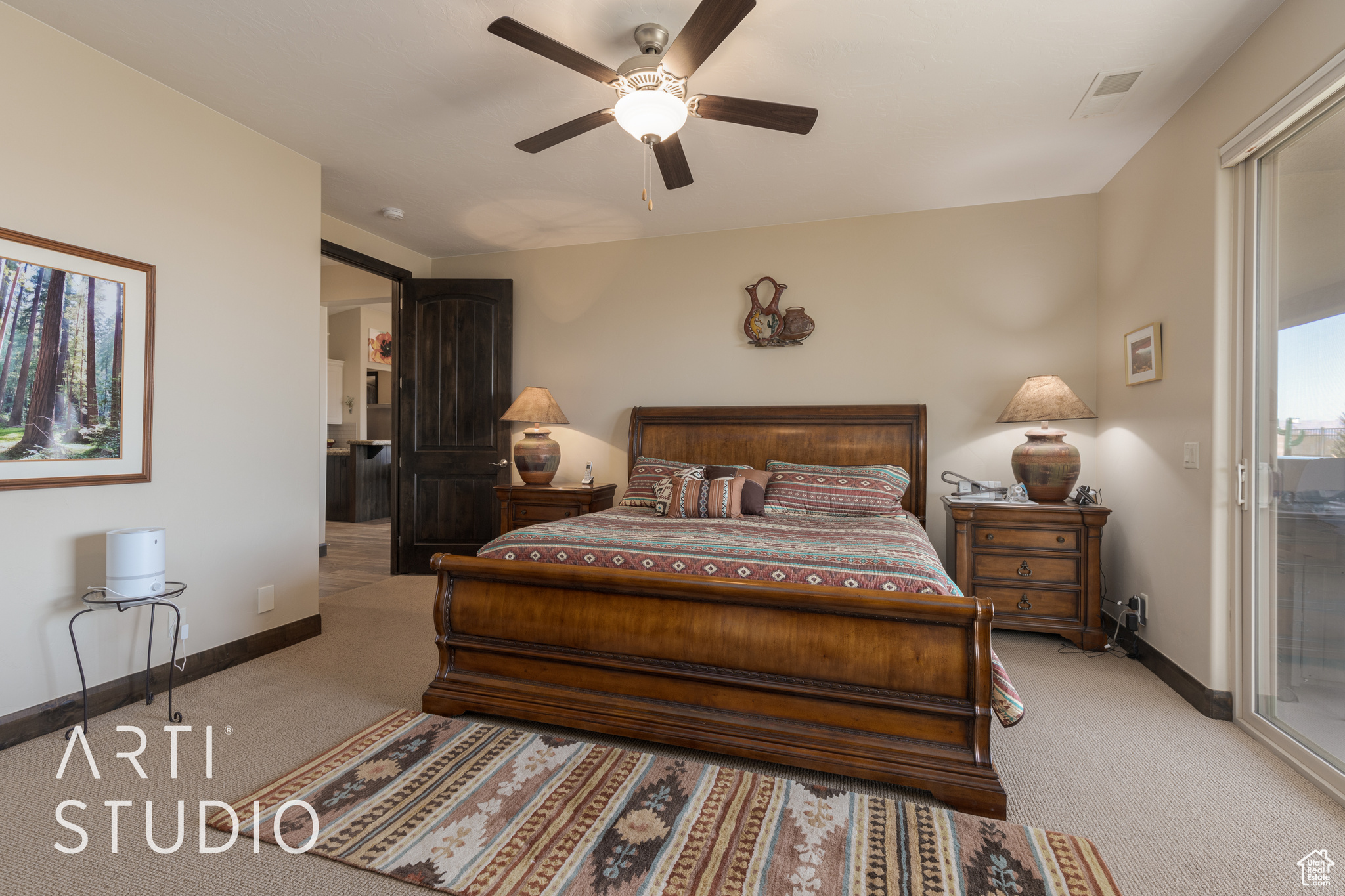 Master bedroom featuring access to exterior and ceiling fan