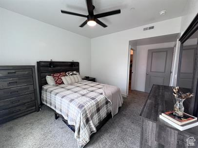 Bedroom featuring dark colored carpet and ceiling fan