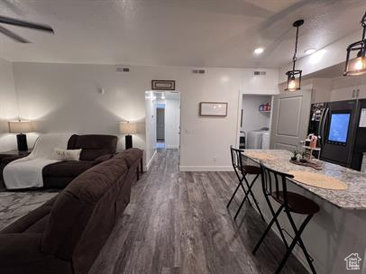 Living room featuring dark hardwood / wood-style flooring and ceiling fan